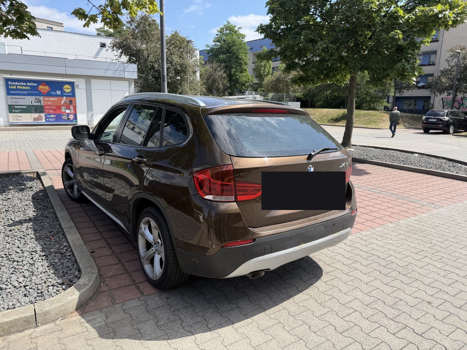 Brauner BMW X1 mit Heckschaden, Kennzeichen abgedeckt